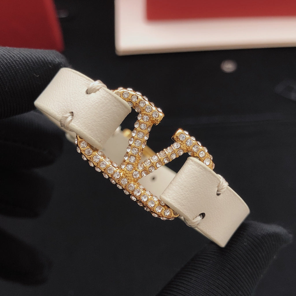 Signature Emblem Bracelet in Gold-Tone – White close-up view