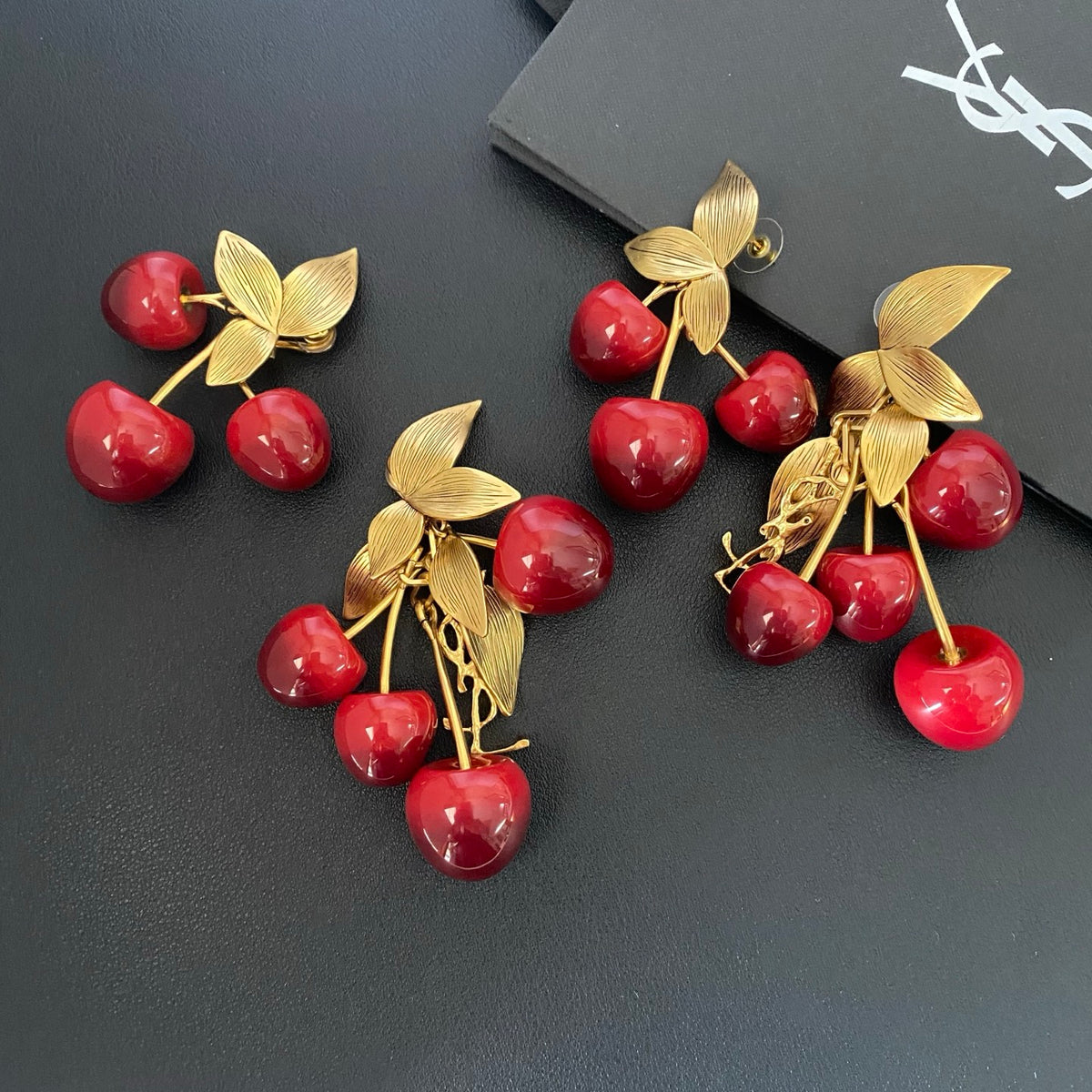 Saint Laurent Cherry Statement Earrings in Polished Metal-Tone close-up detail