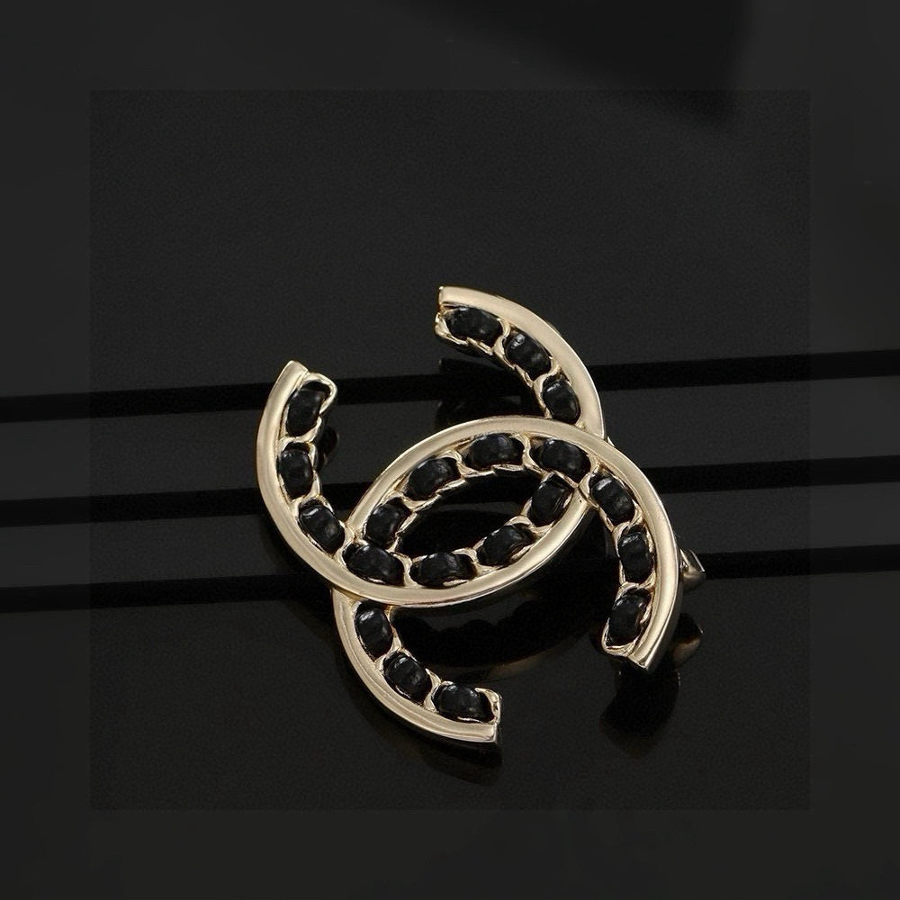 Double-C Emblem Brooch in Polished Metal-Tone – Black Detail – Design 002 detail view
