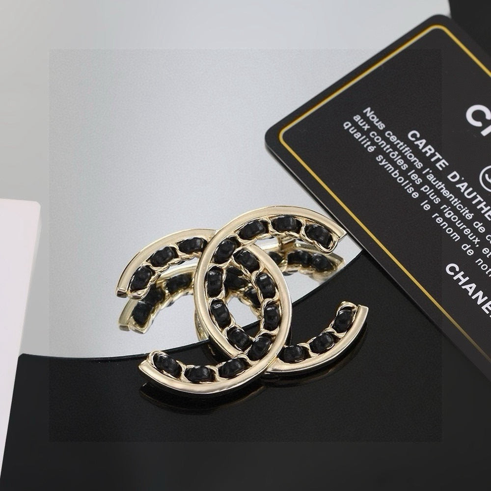 Double-C Emblem Brooch in Polished Metal-Tone – Black Detail close-up detail