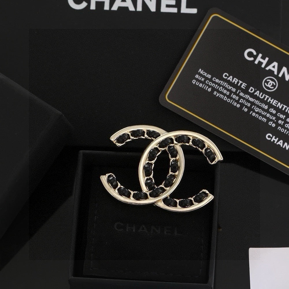 Double-C Emblem Brooch in Polished Metal-Tone – Black Detail front product view