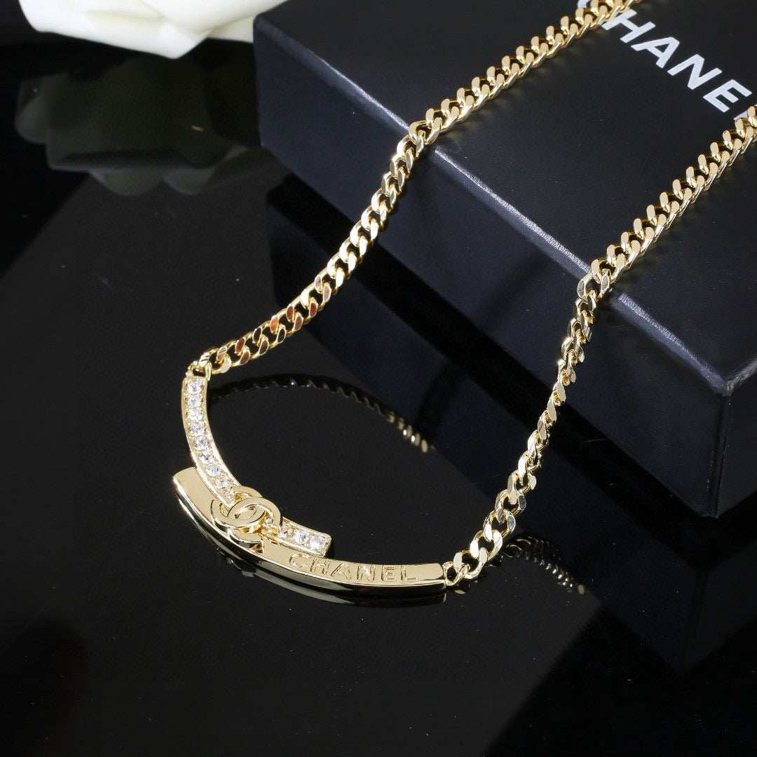 Double-C Emblem Pendant Necklace in Polished Metal-Tone – White Detail main product view