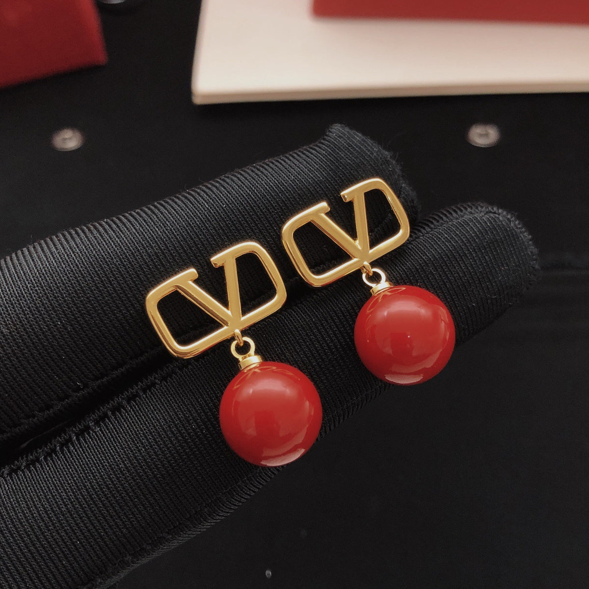 Signature Emblem Pearl-Detail Stud Earrings – Red front view