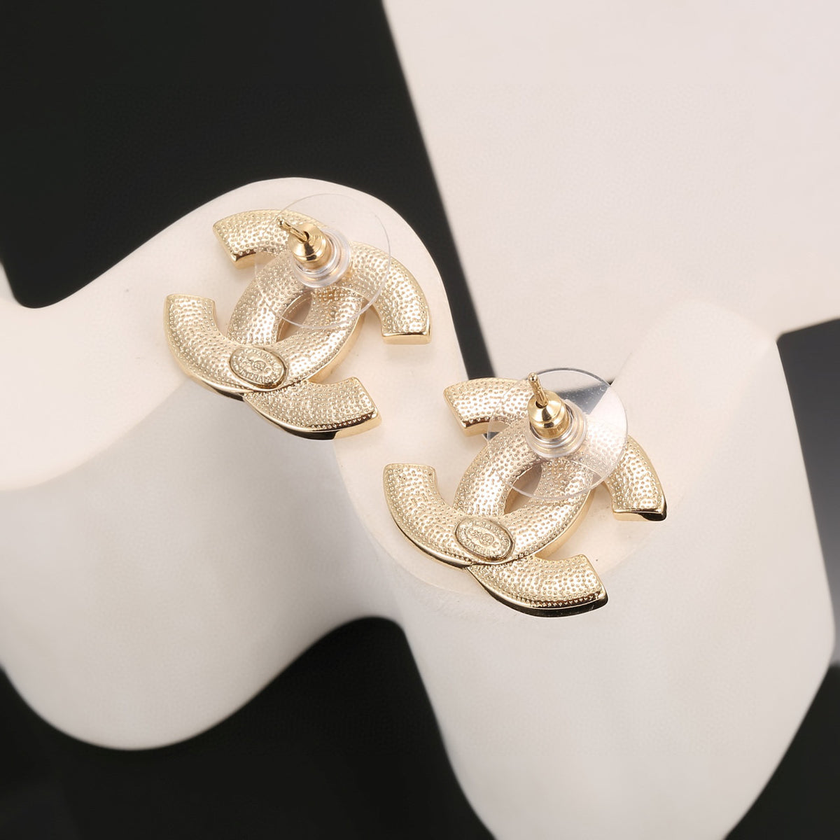 Double-C Emblem Stud Earrings in Polished Metal-Tone – Design 438 close-up detail