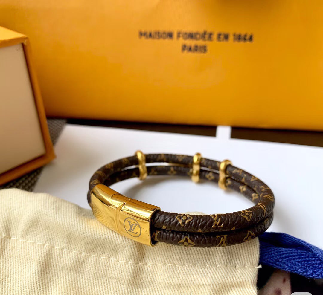 Letter Emblem Bangle in Polished Metal-Tone – Leather Detail styled product view