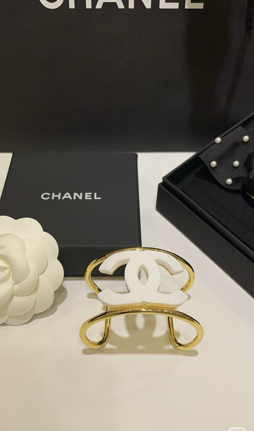 Signature Emblem Bangle in Polished Metal-Tone – White Detail front product view