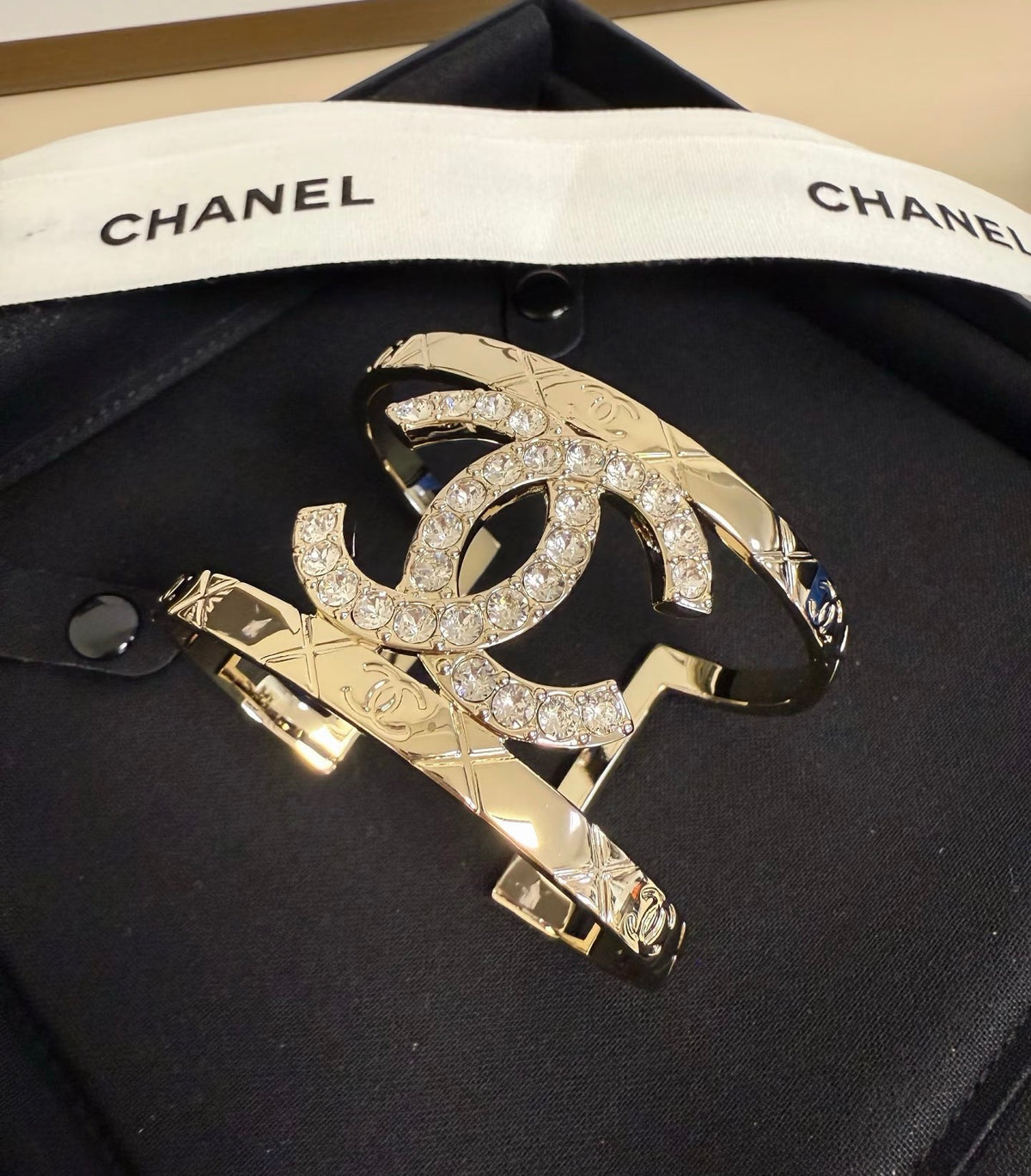 Signature Emblem Bangle in Polished Metal-Tone – Black Detail main product view