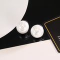 Double-C Emblem Stud Earrings in Polished Metal-Tone – White Detail main product view