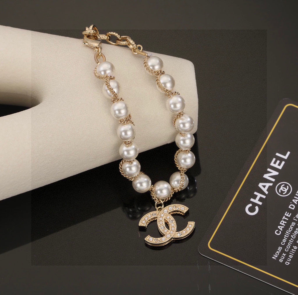 Double-C Emblem Bracelet in Polished Metal-Tone – Pearl Detail styled product view