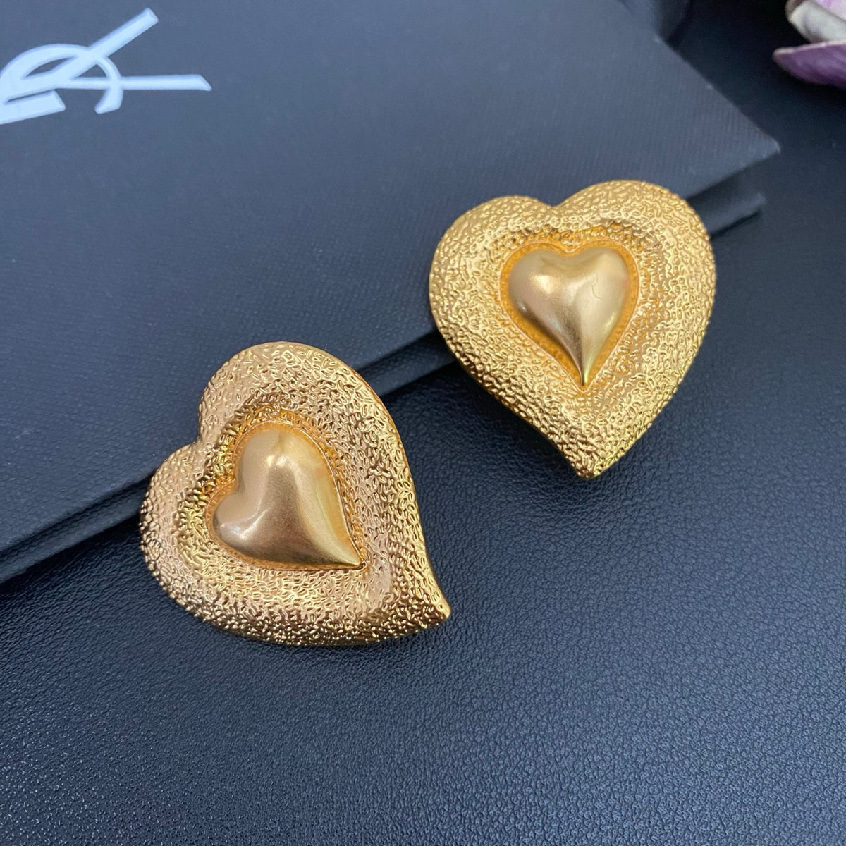 Saint Laurent Heart Statement Earrings in Polished Metal-Tone close-up detail