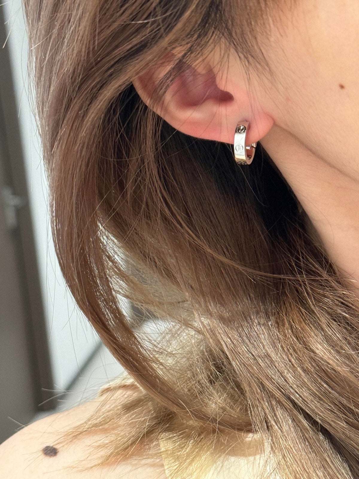 Martin Graham stud earrings in polished metal-tone – side detail