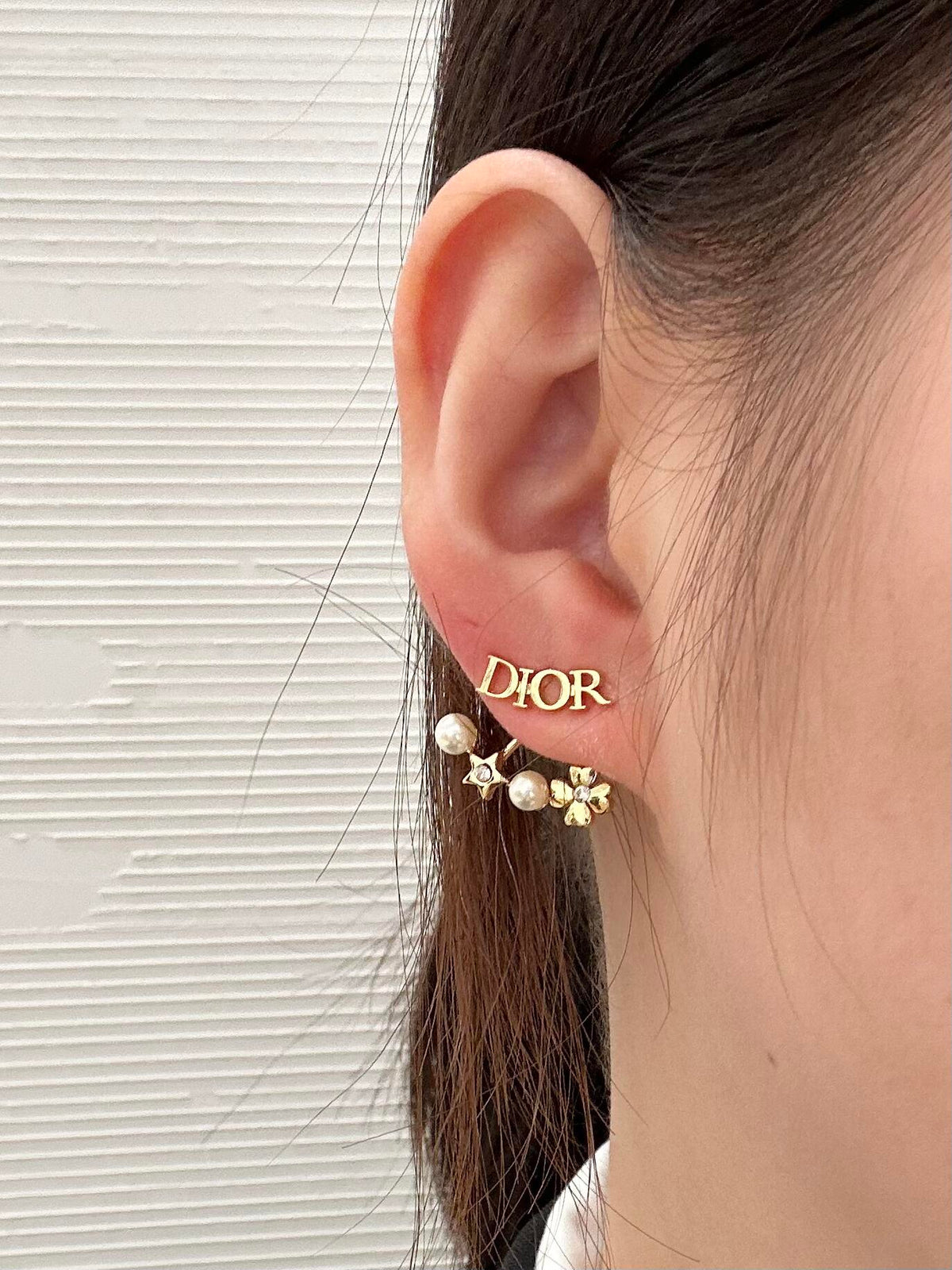 Martin Graham stud earrings in polished metal-tone – side detail
