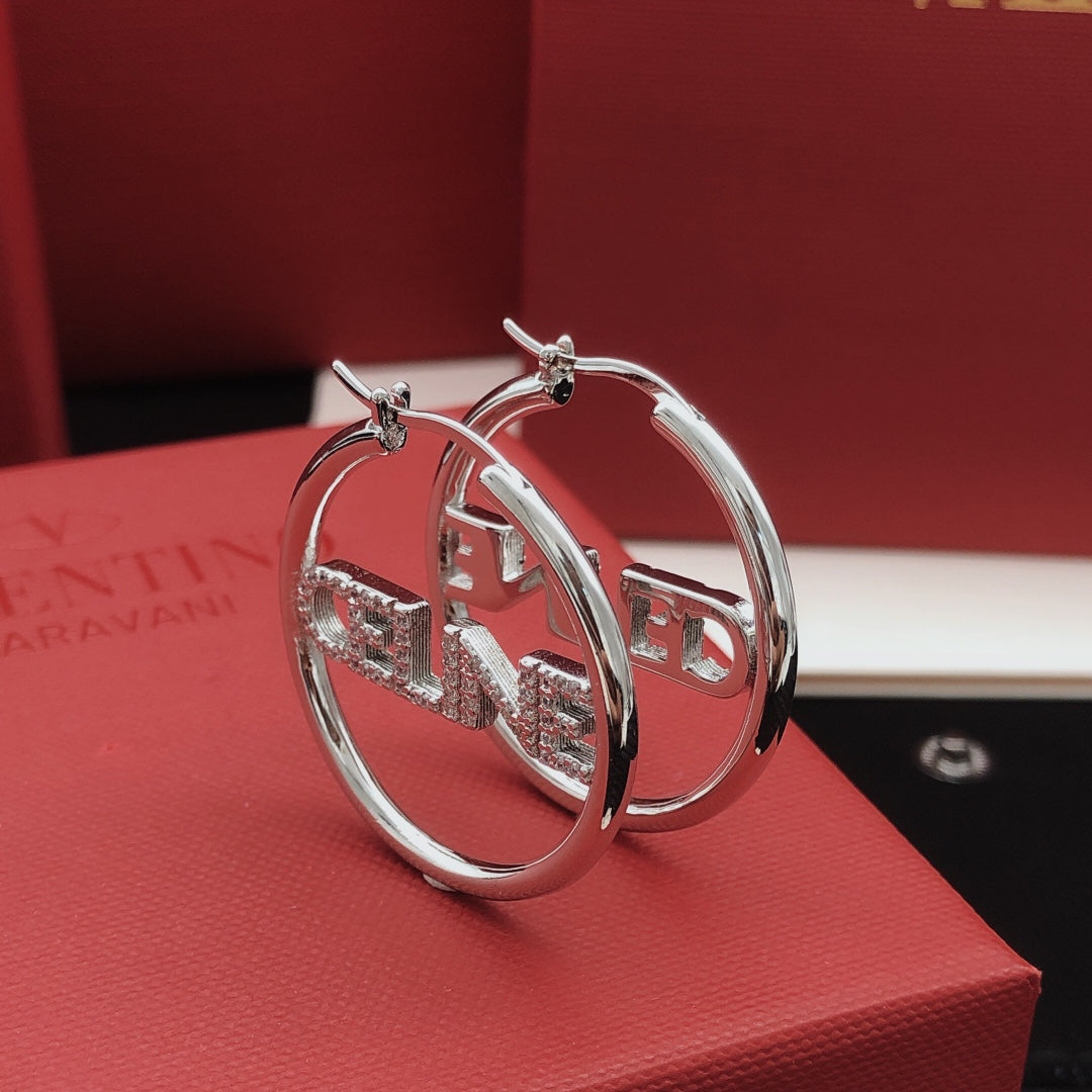 Martin Graham drop earrings in polished metal-tone – front view