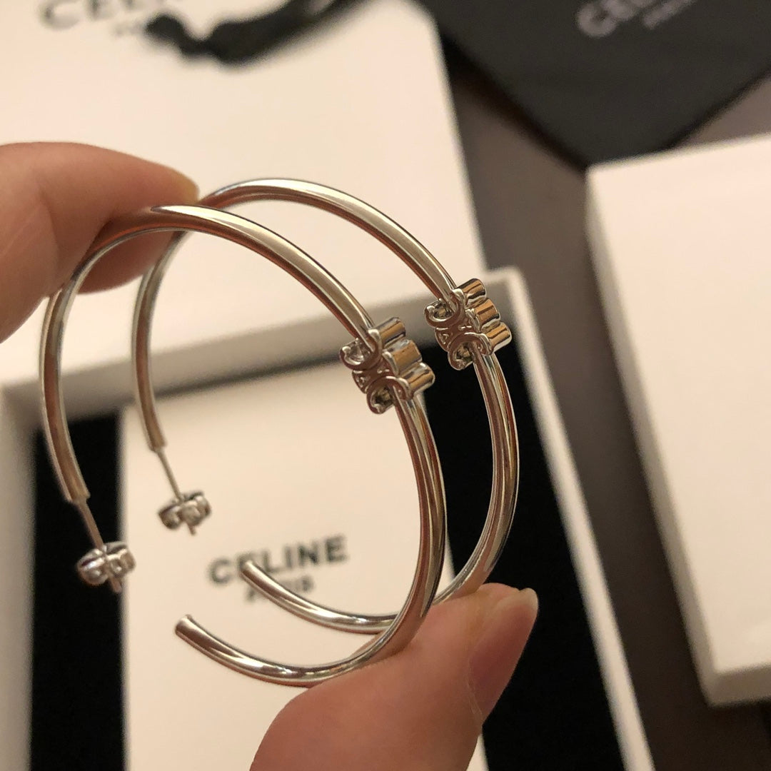 Martin Graham earrings in polished metal-tone – front view