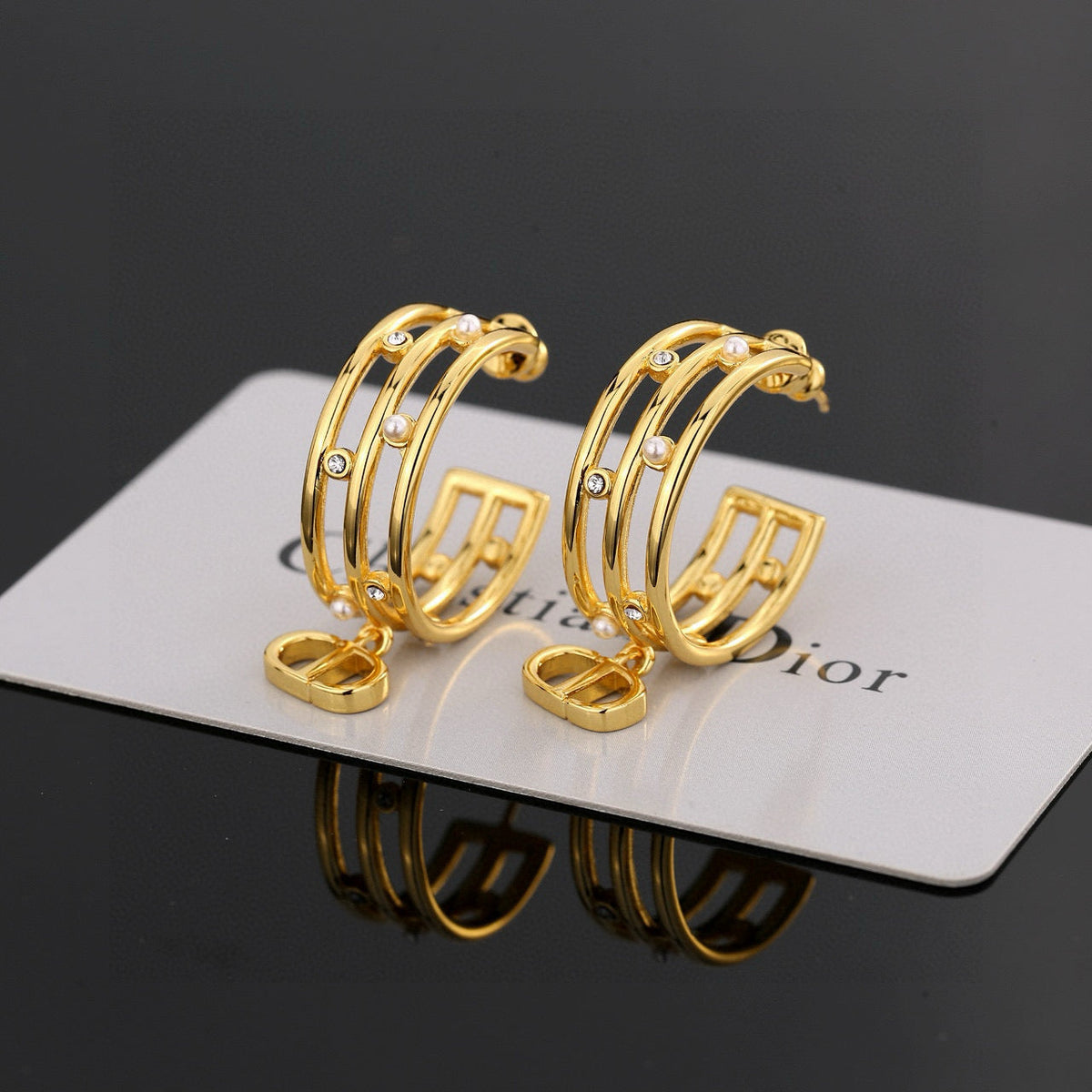 Martin Graham stud earrings in polished metal-tone – front view