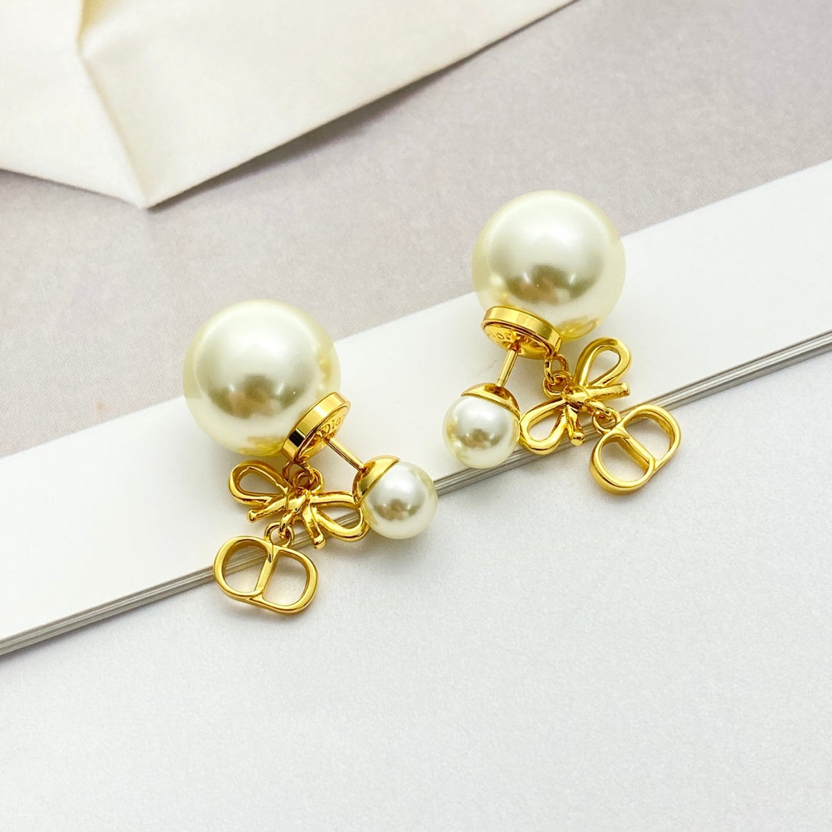 Martin Graham stud earrings in polished metal-tone – front view