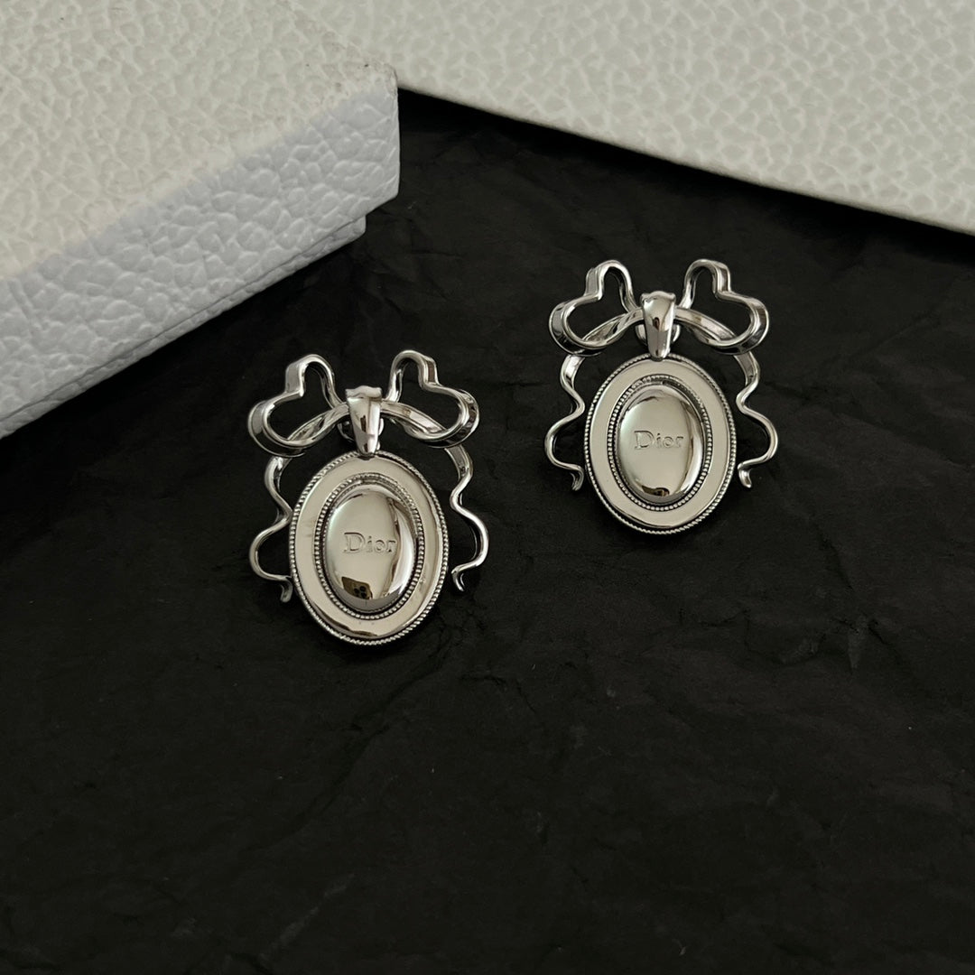 Martin Graham stud earrings in polished metal-tone – front view