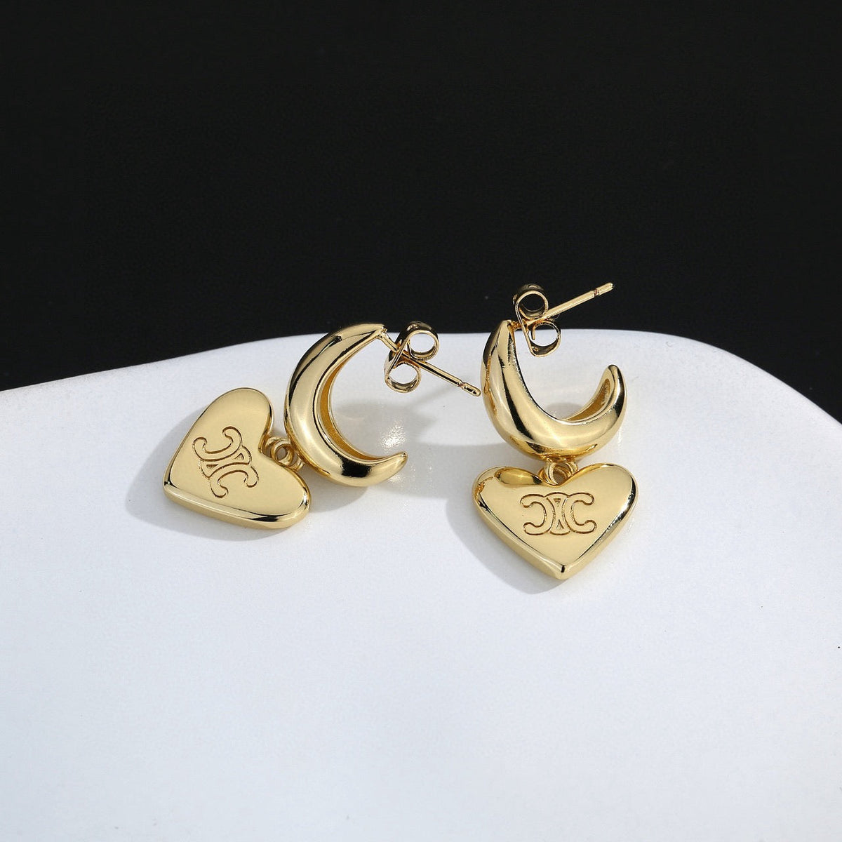 Martin Graham stud earrings in polished metal-tone – front view