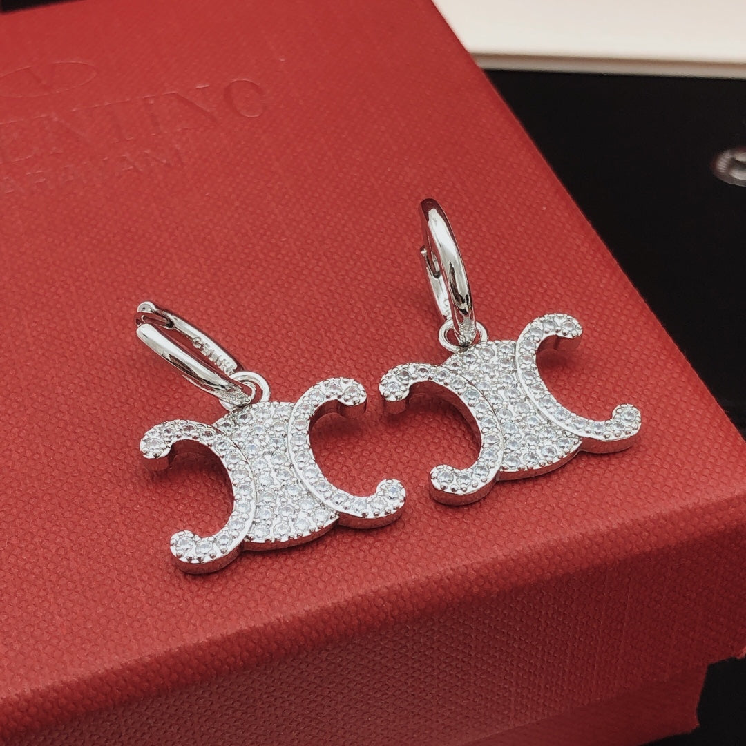 Martin Graham drop earrings in polished metal-tone – front view