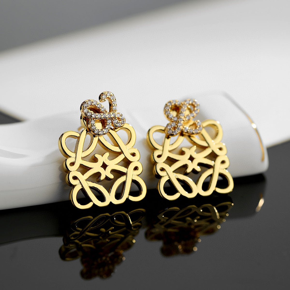 Martin Graham stud earrings in polished metal-tone – front view