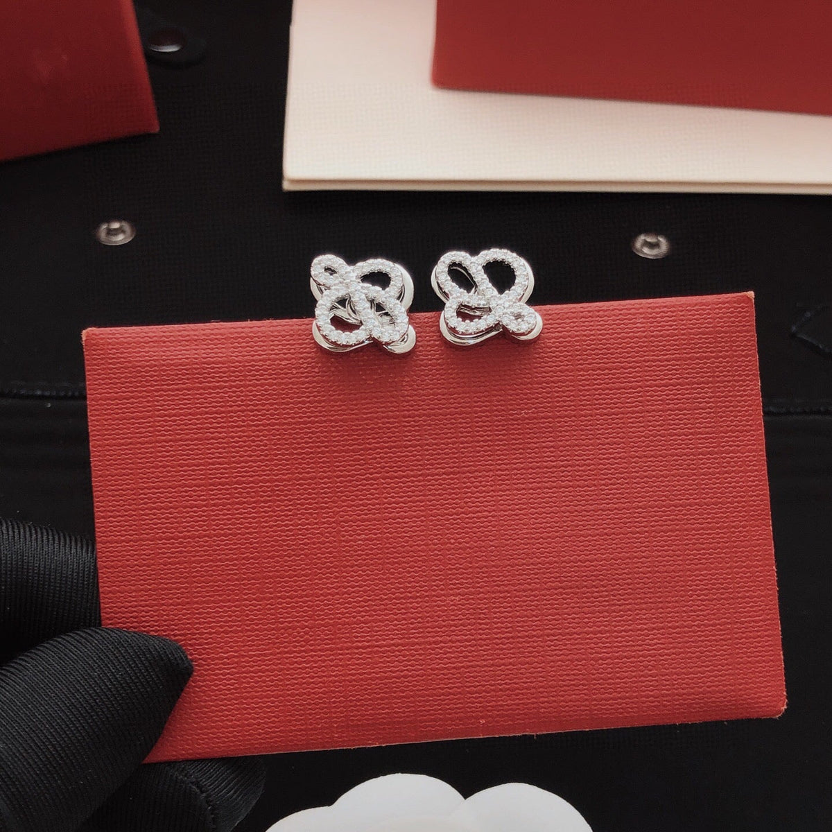 Martin Graham stud earrings in polished metal-tone – front view
