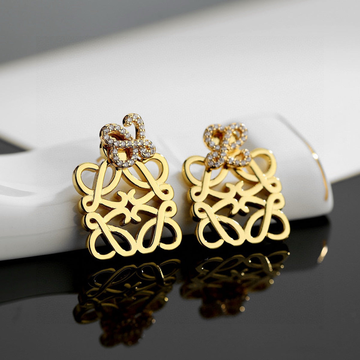 Martin Graham stud earrings in polished metal-tone – front view