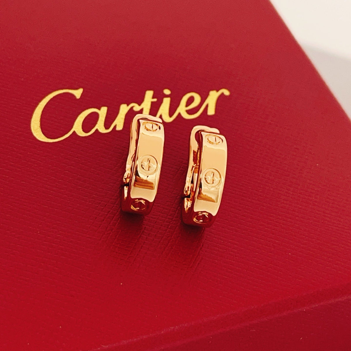 Martin Graham stud earrings in polished metal-tone – front view