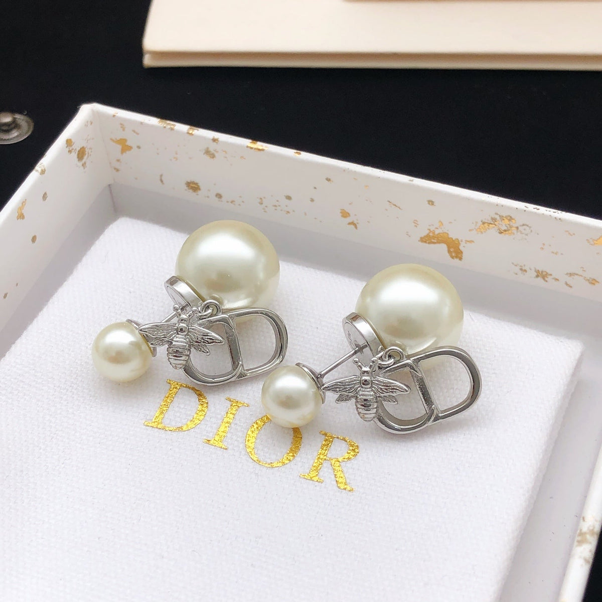 Martin Graham stud earrings in polished metal-tone – front view