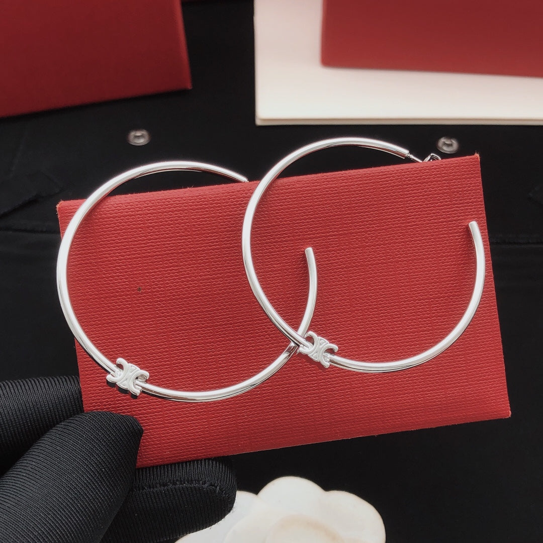Martin Graham earrings in polished metal-tone – front view
