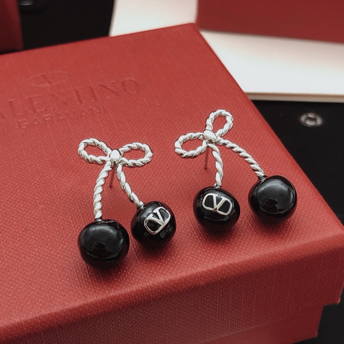 Martin Graham stud earrings in polished metal-tone – front view