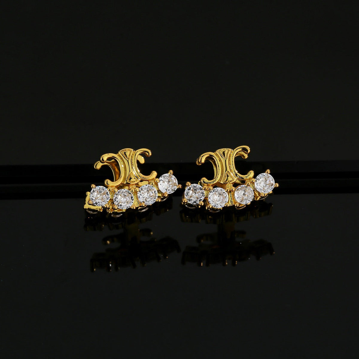 Martin Graham stud earrings in polished metal-tone – front view