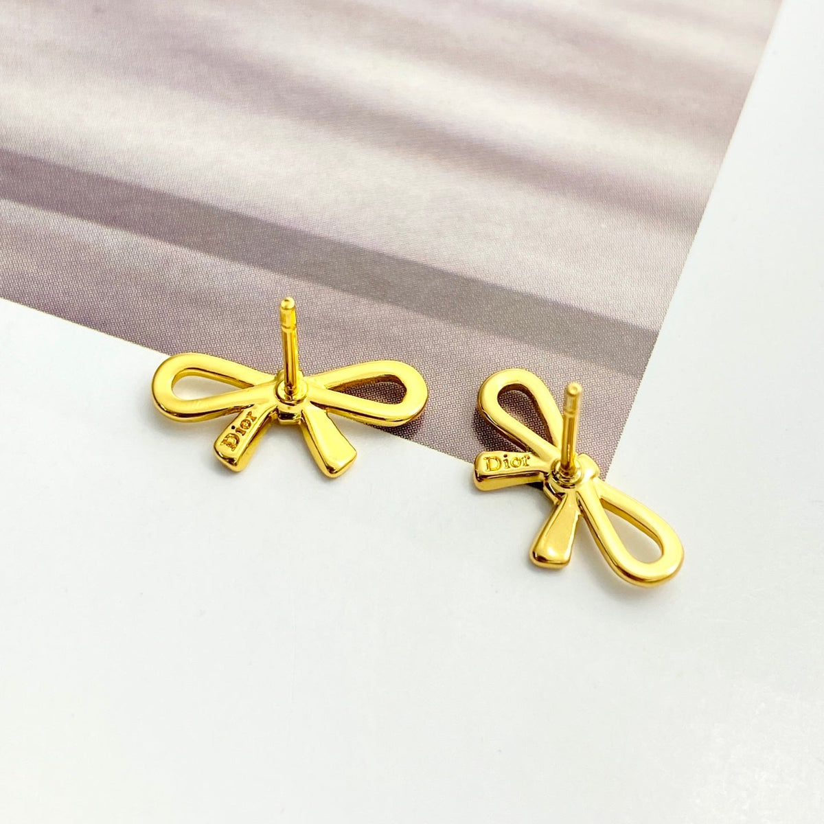 Martin Graham stud earrings in polished metal-tone – front view
