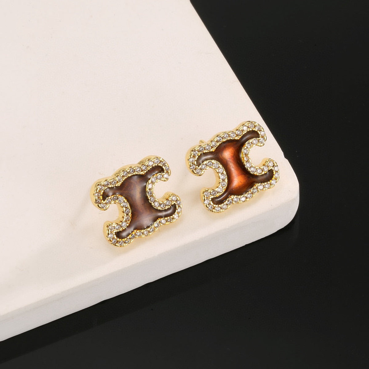 Martin Graham stud earrings in polished metal-tone – front view