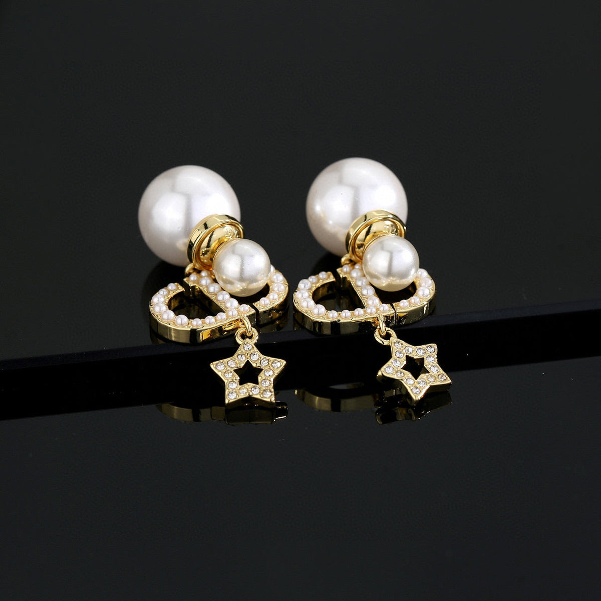 Martin Graham stud earrings in polished metal-tone – detail view