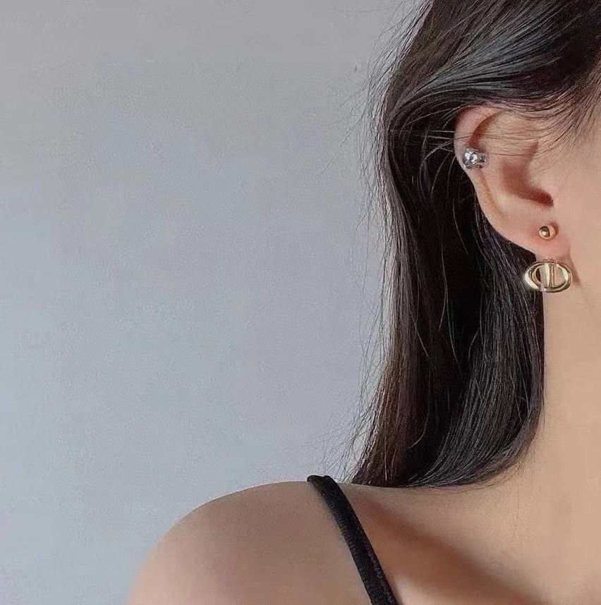 Martin Graham stud earrings in polished metal-tone – detail view