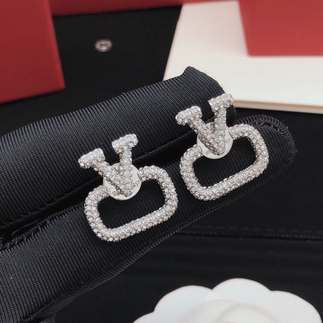 Martin Graham stud earrings in polished metal-tone – detail view