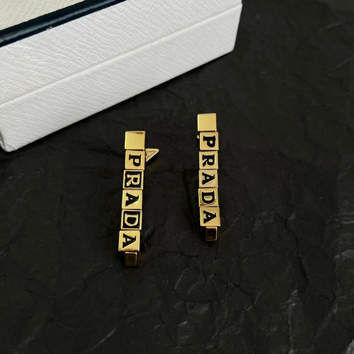 Martin Graham stud earrings in polished metal-tone – detail view