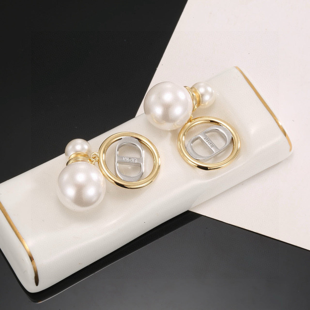 Martin Graham stud earrings in polished metal-tone – detail view