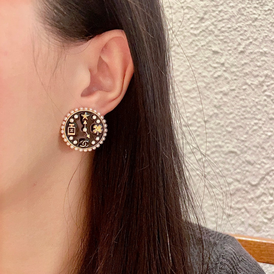 Martin Graham stud earrings in polished metal-tone – detail view