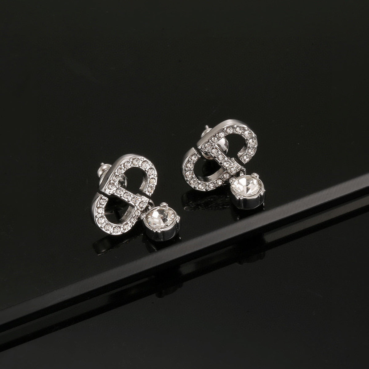 Martin Graham stud earrings in polished metal-tone – detail view