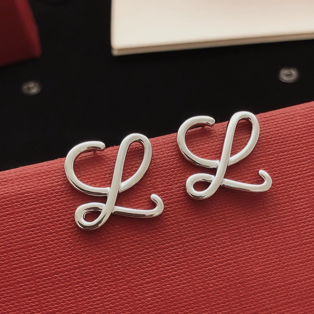 Martin Graham stud earrings in polished metal-tone – detail view