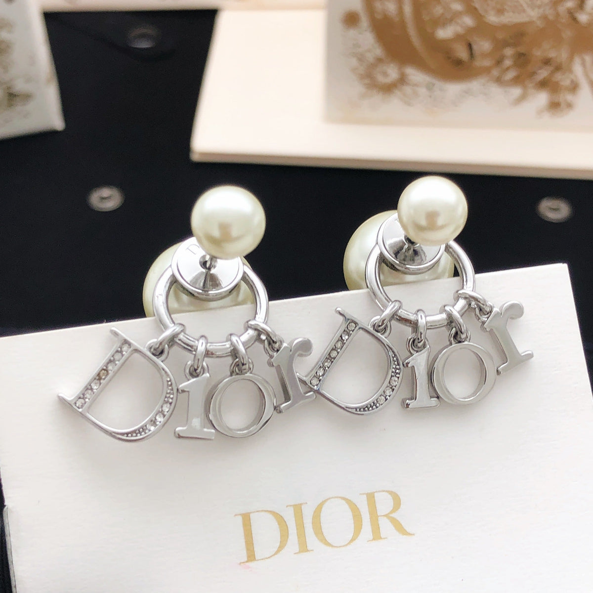 Martin Graham stud earrings in polished metal-tone – detail view