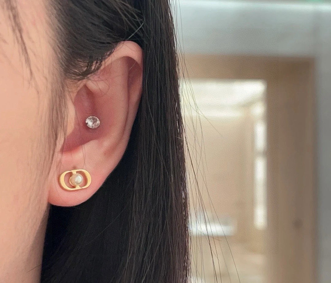 Martin Graham stud earrings in polished metal-tone – detail view