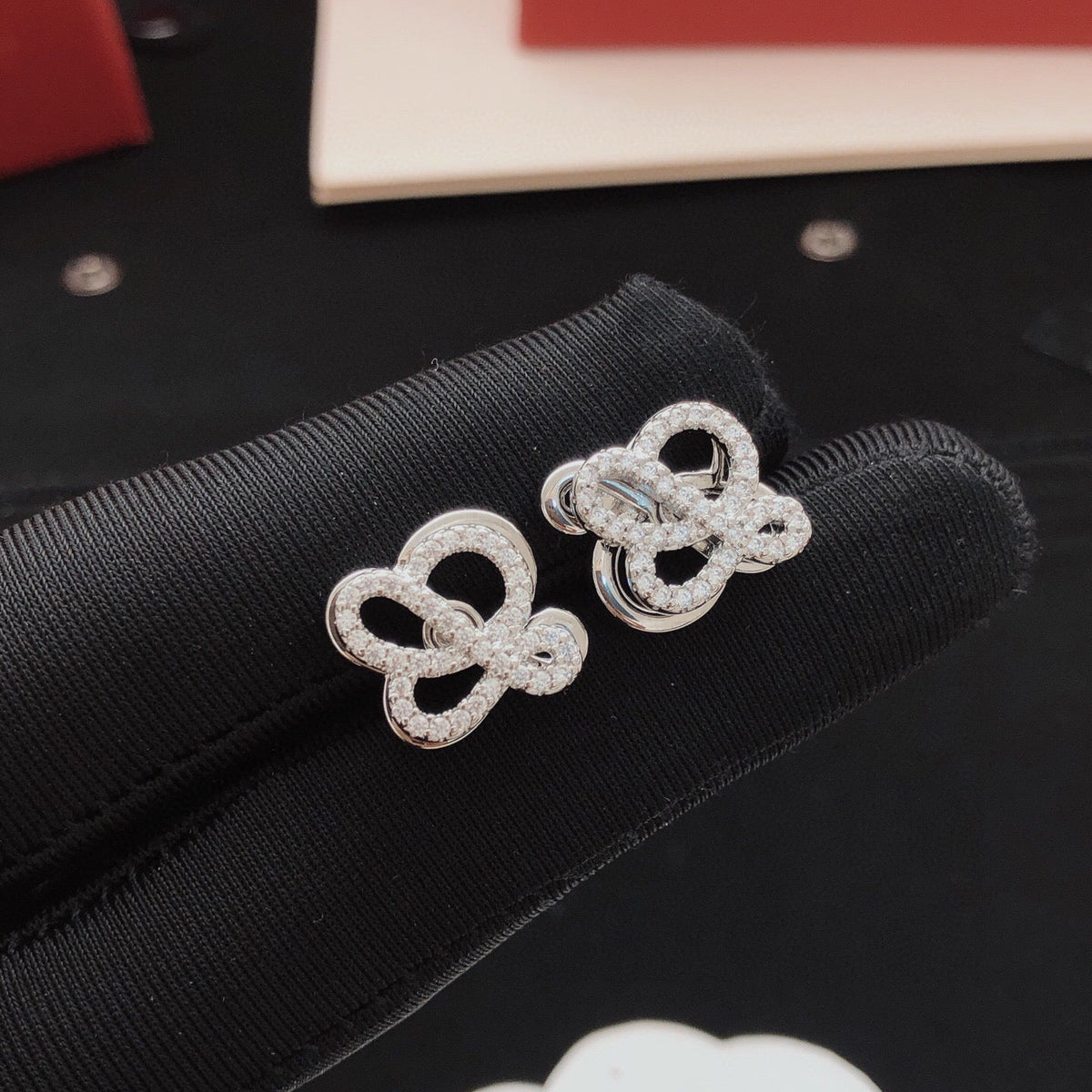 Martin Graham stud earrings in polished metal-tone – detail view
