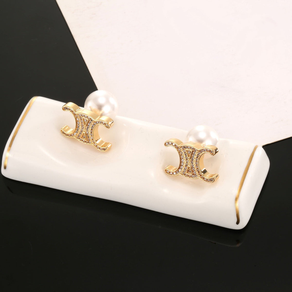 Martin Graham stud earrings in polished metal-tone – detail view