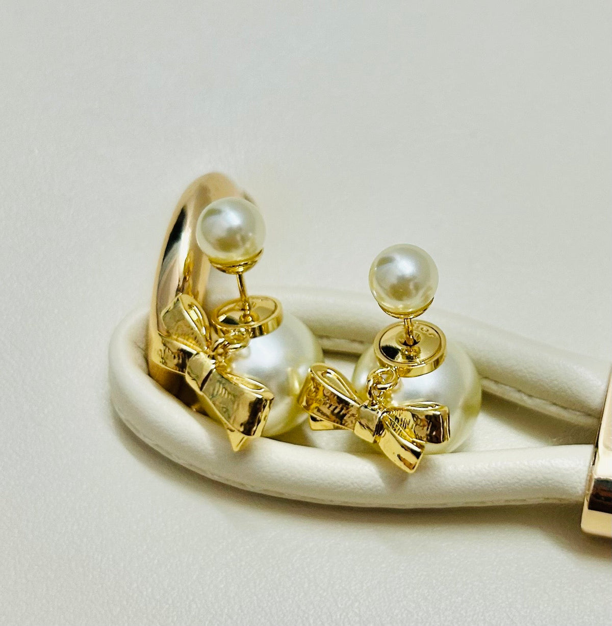 Martin Graham stud earrings in polished metal-tone – detail view