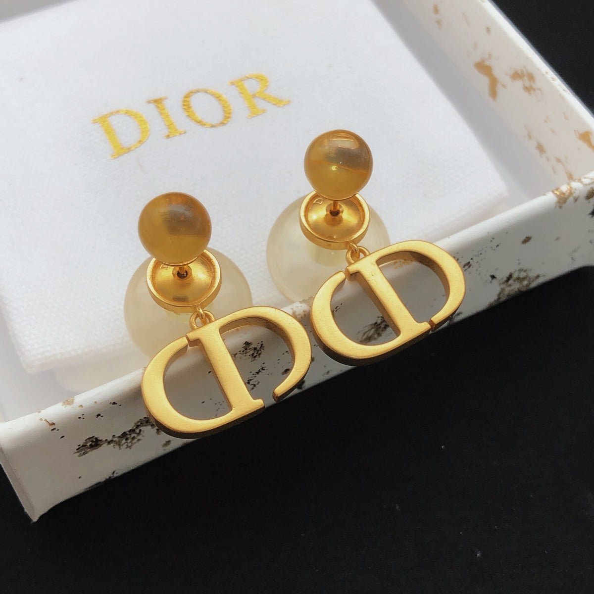 Martin Graham stud earrings in polished metal-tone – detail view