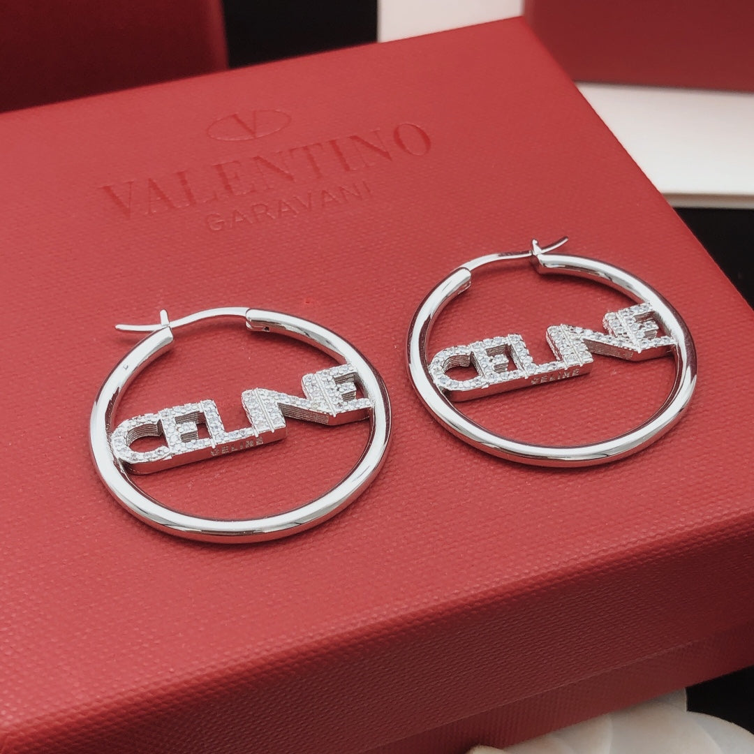Martin Graham drop earrings in polished metal-tone – detail view
