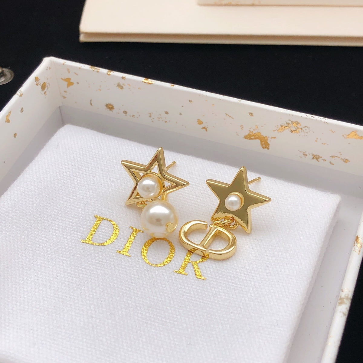 Martin Graham stud earrings in polished metal-tone – detail view