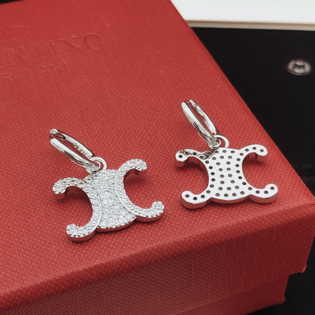 Martin Graham drop earrings in polished metal-tone – detail view
